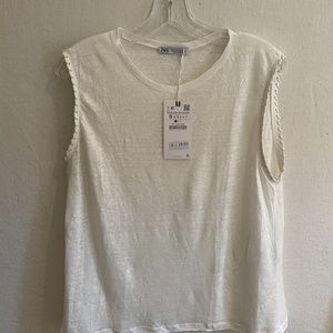 White sleeveless top with pleather stitching